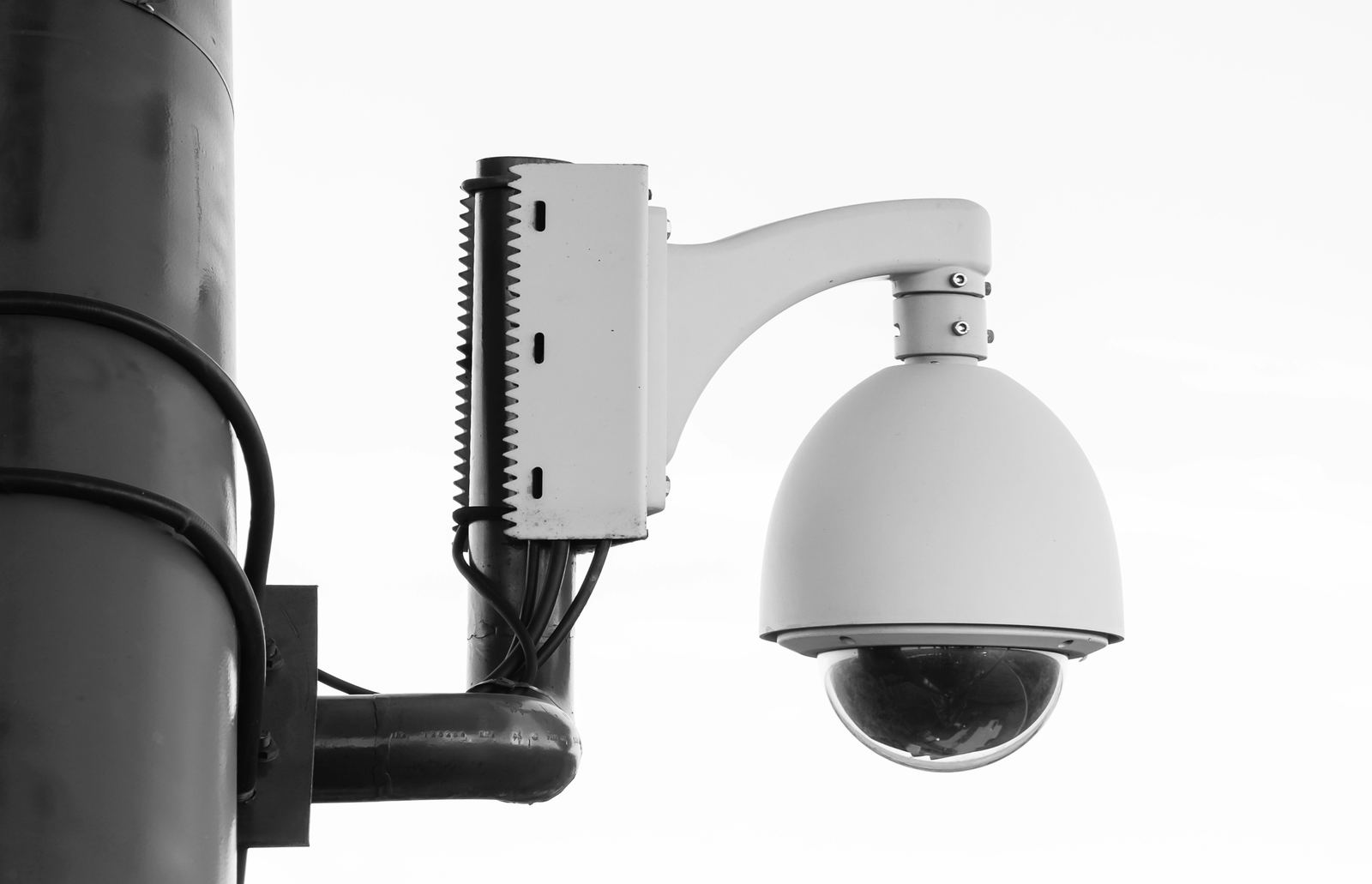 White security camera mounted on a post
