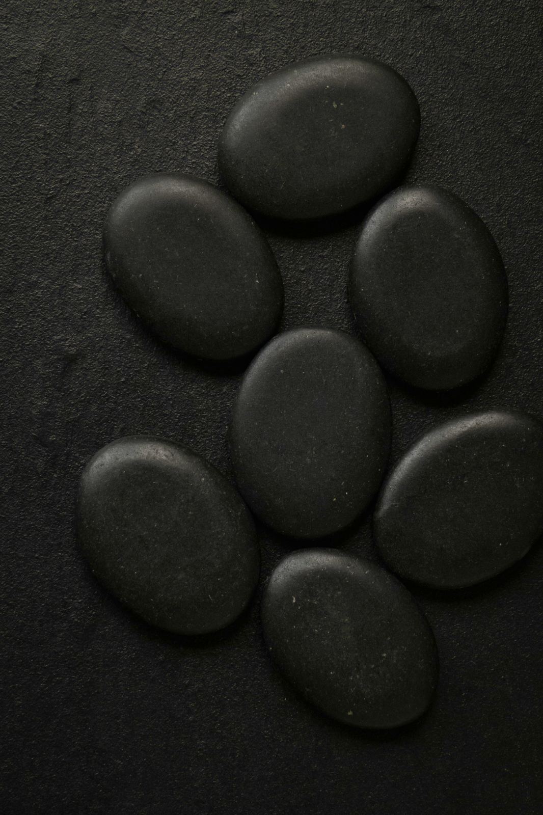 Small stack of dark smooth pebbles