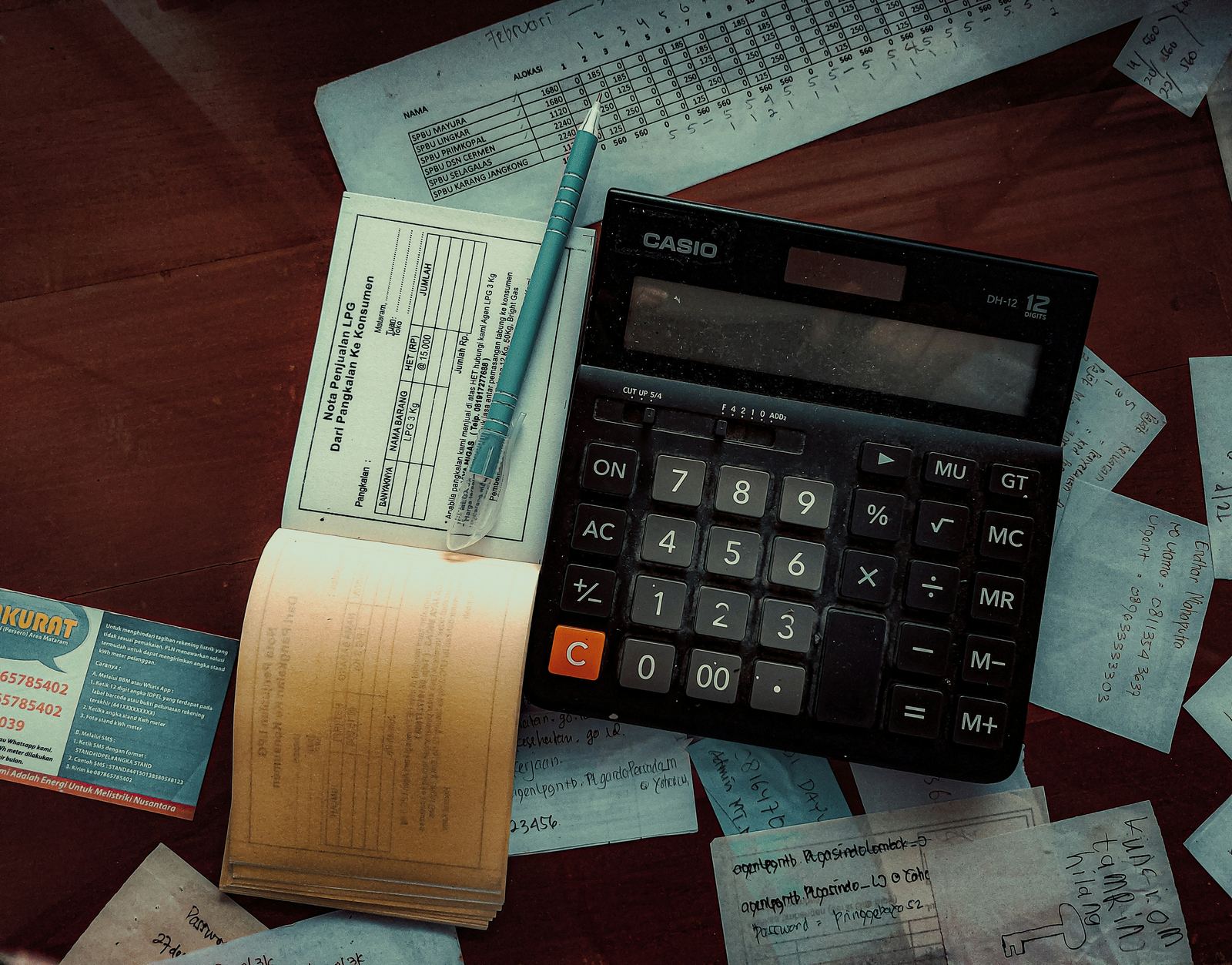 Calculator and receipts on a wooden desk