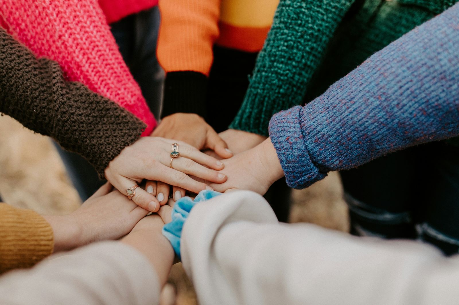Group of hands stacked together in a circle